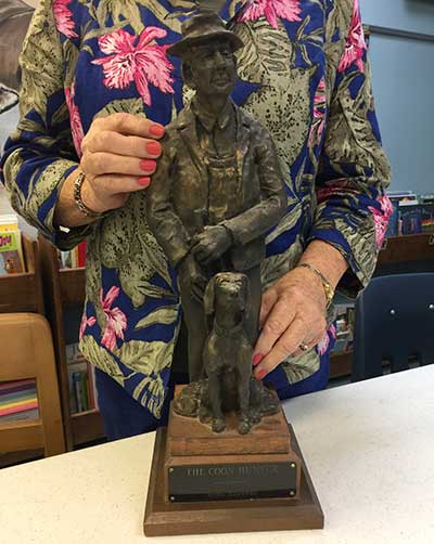 coon hunter sculpture
